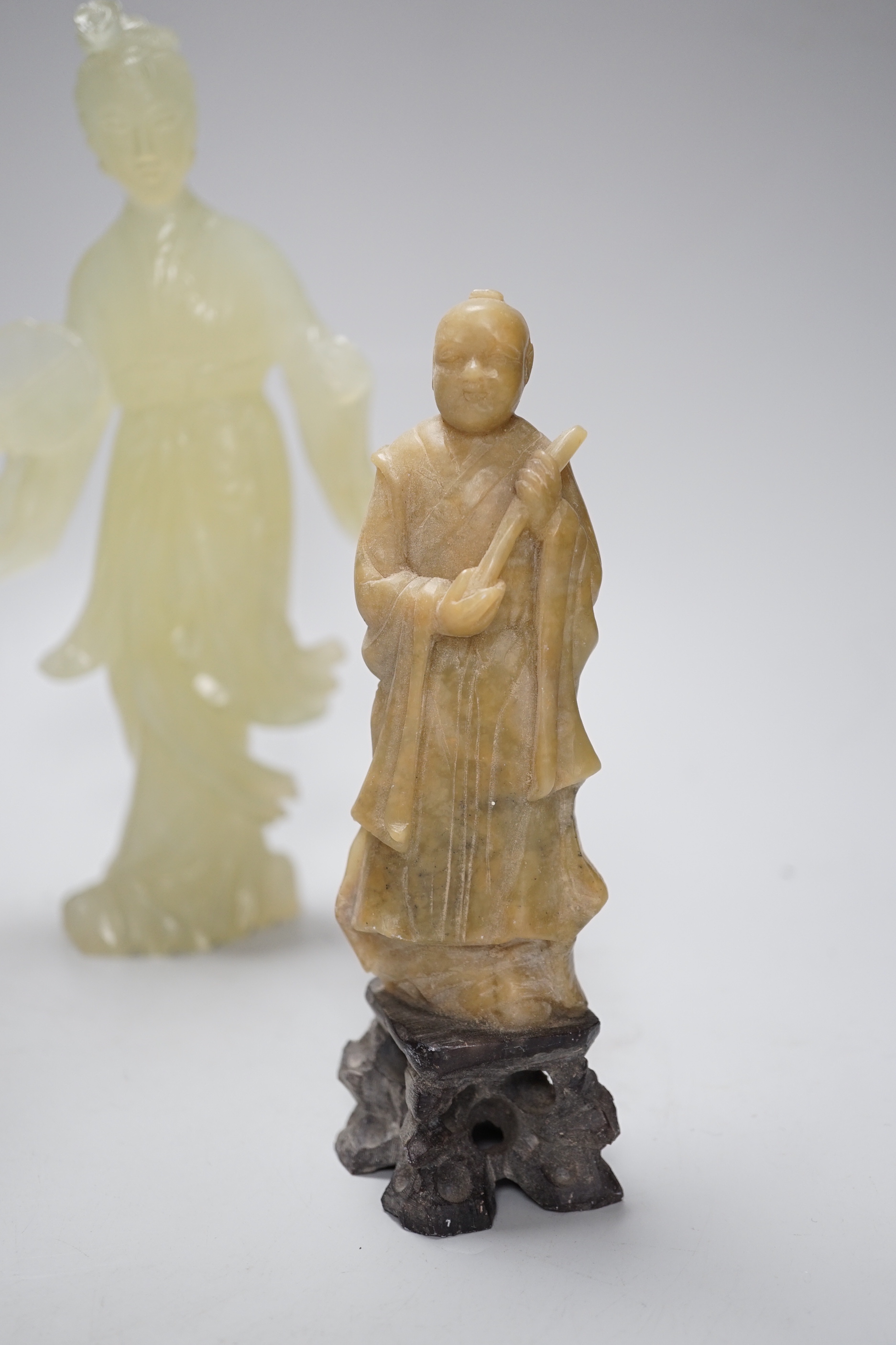 A Chinese bowenite figure and four Chinese carved soapstone figures, the largest 21cm high (5)
